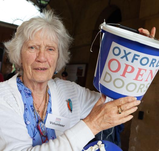 Volunteer with bucket at oxford open doors