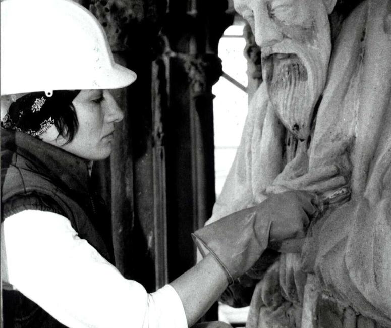 A person in a hard hat restoring the martyrs memorial