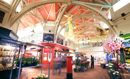 An image of the covered market in Oxford, with a red postbox in the middle