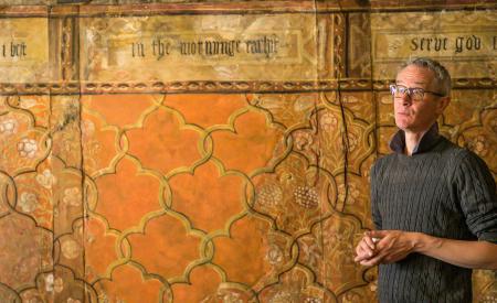 Man stood in front of wall painting