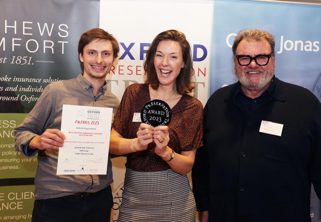 Three people at the OPT award holding their award