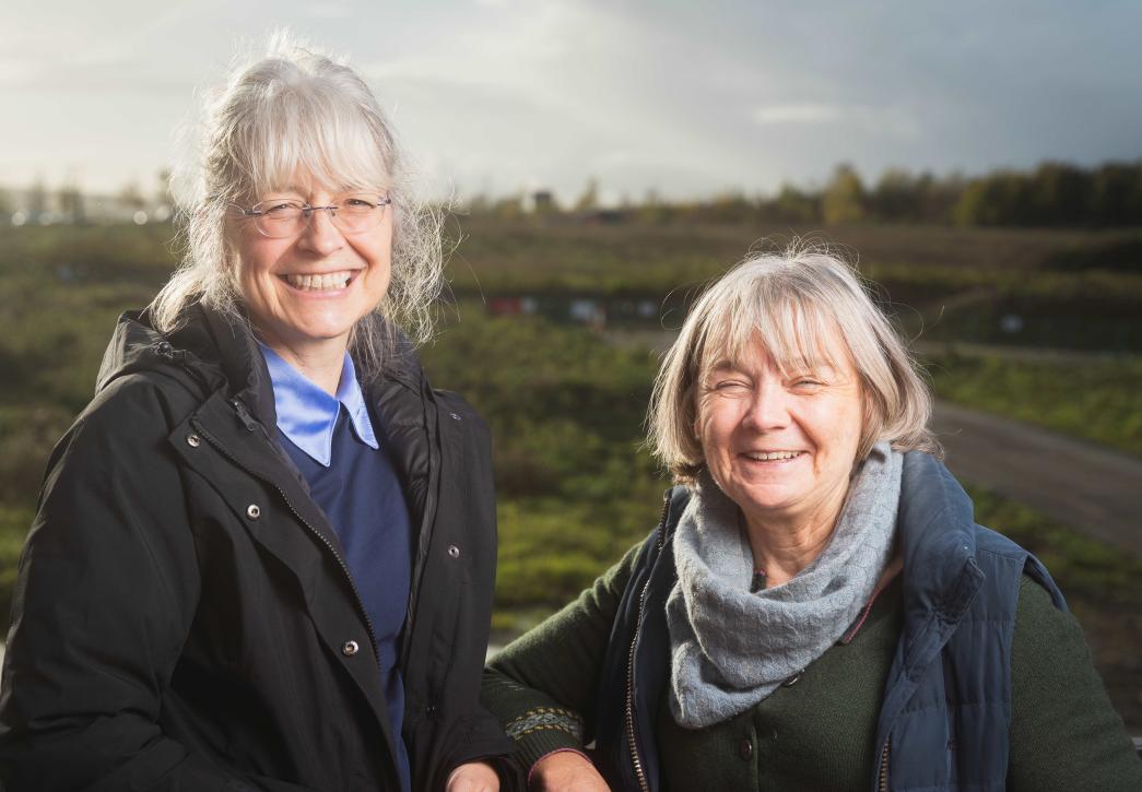 Debbie and Anna standing in a field laughing