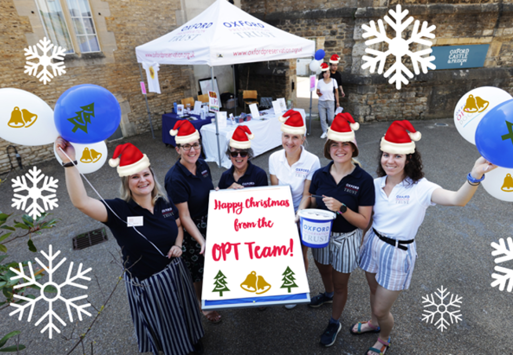 OPT team holding up balloons and wearing christmas hats