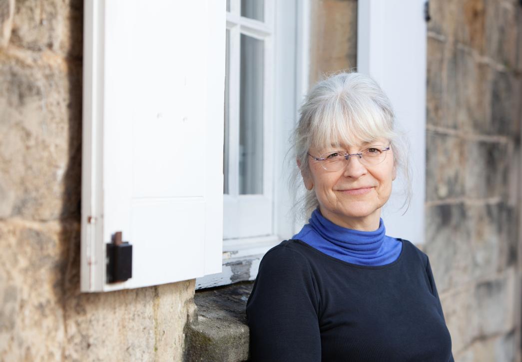 Anna Eavis standing in front of OPT offices