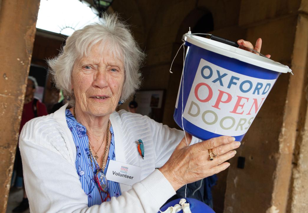 Volunteer with bucket at oxford open doors