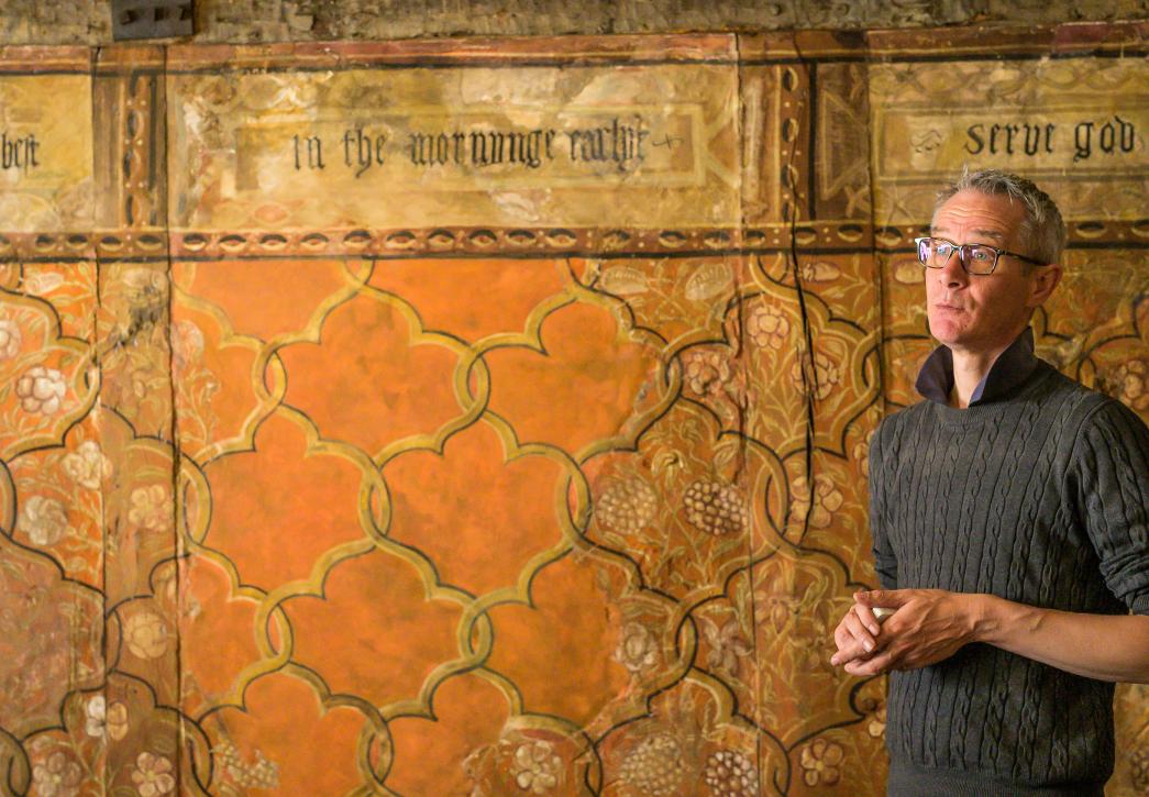 Man stood in front of wall painting